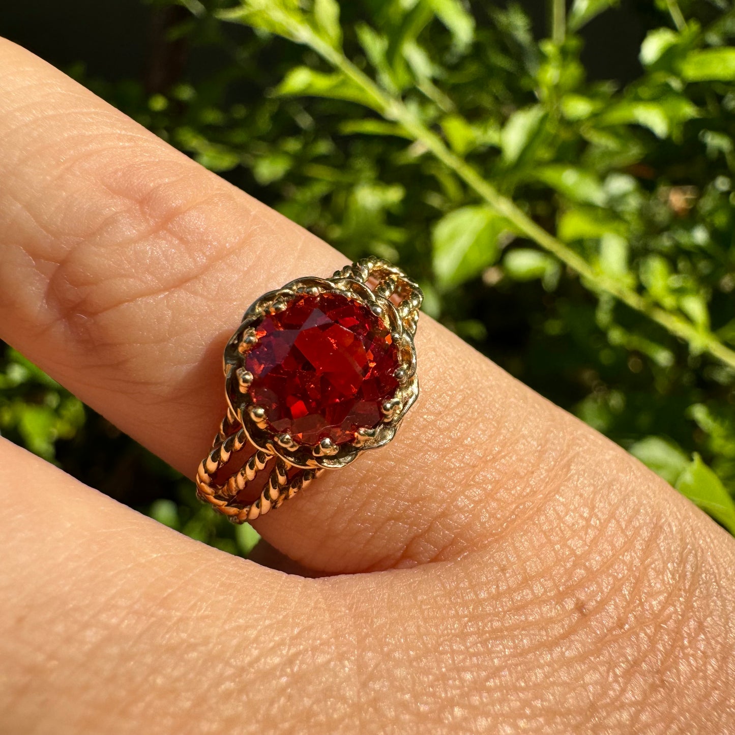 10K gold ring set with a vivid orange gemstone