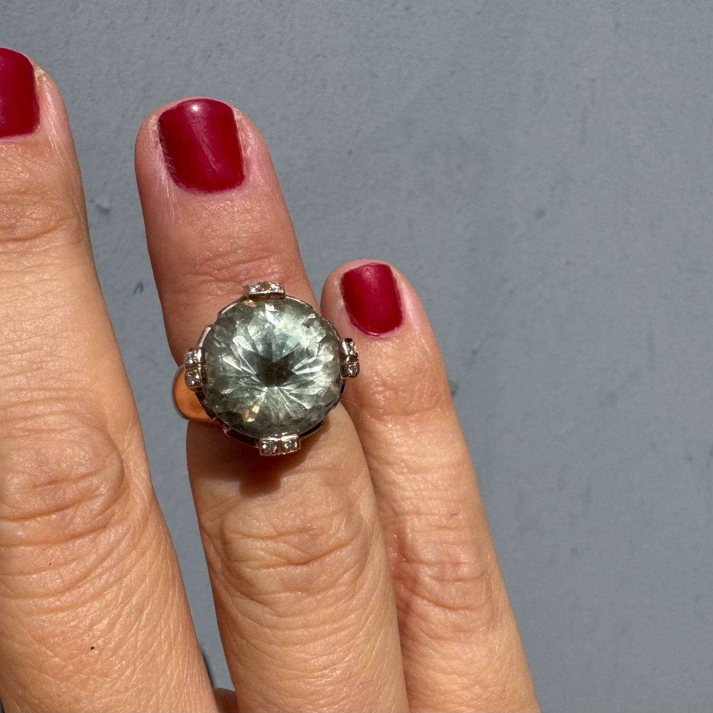 18K gold ring set with a large round Prasiolite gemstone accented by small Diamonds