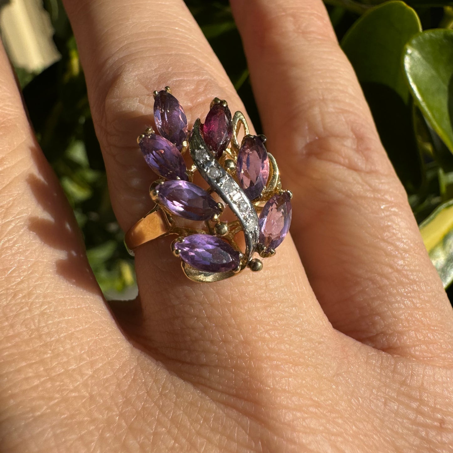 14K gold ring designed in a leaf motif, set with 7 marquise-cut Amethyst and accented by a curved line of sparkling Diamonds