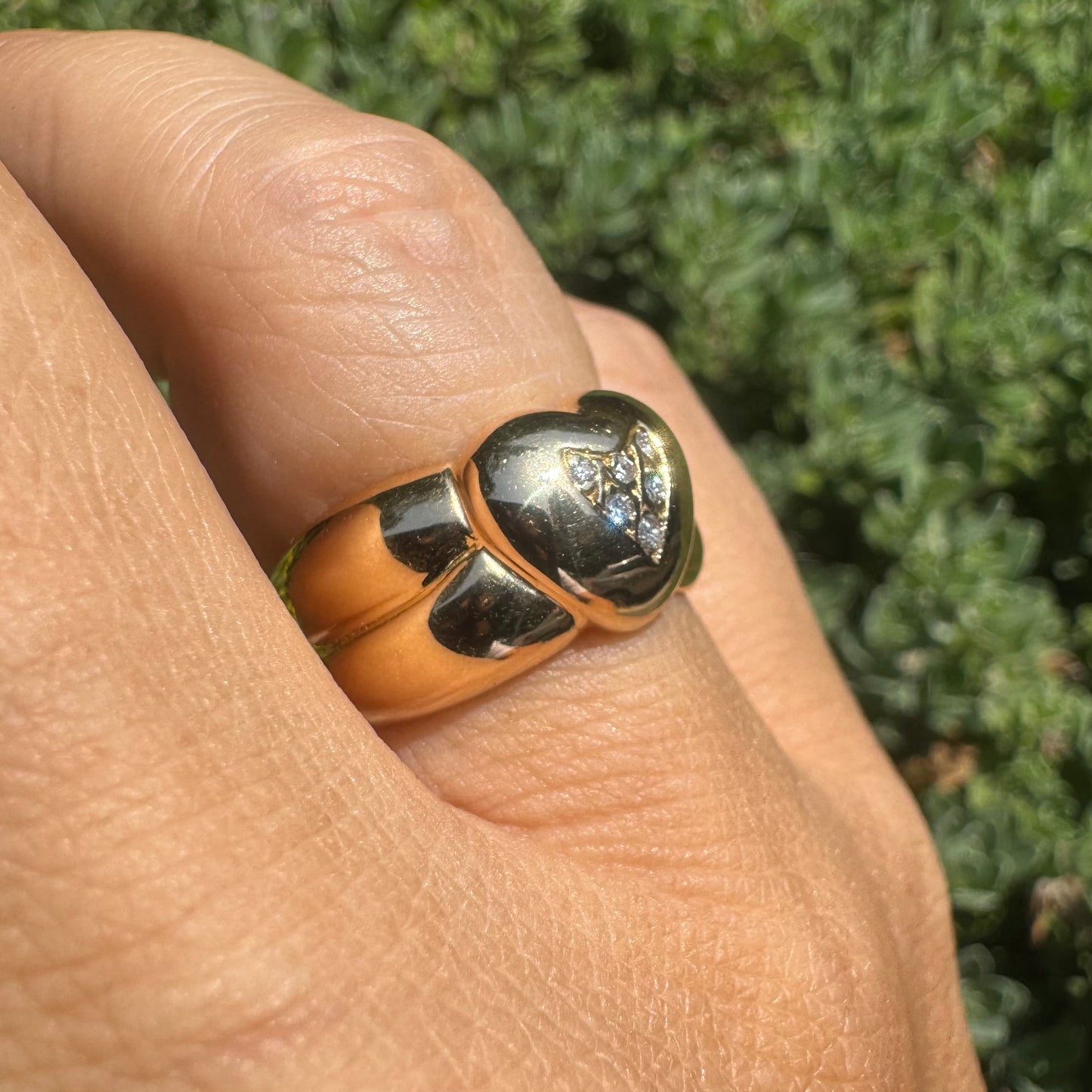 18K gold ring featuring a bold heart design, set with sparkling Diamonds in the center.