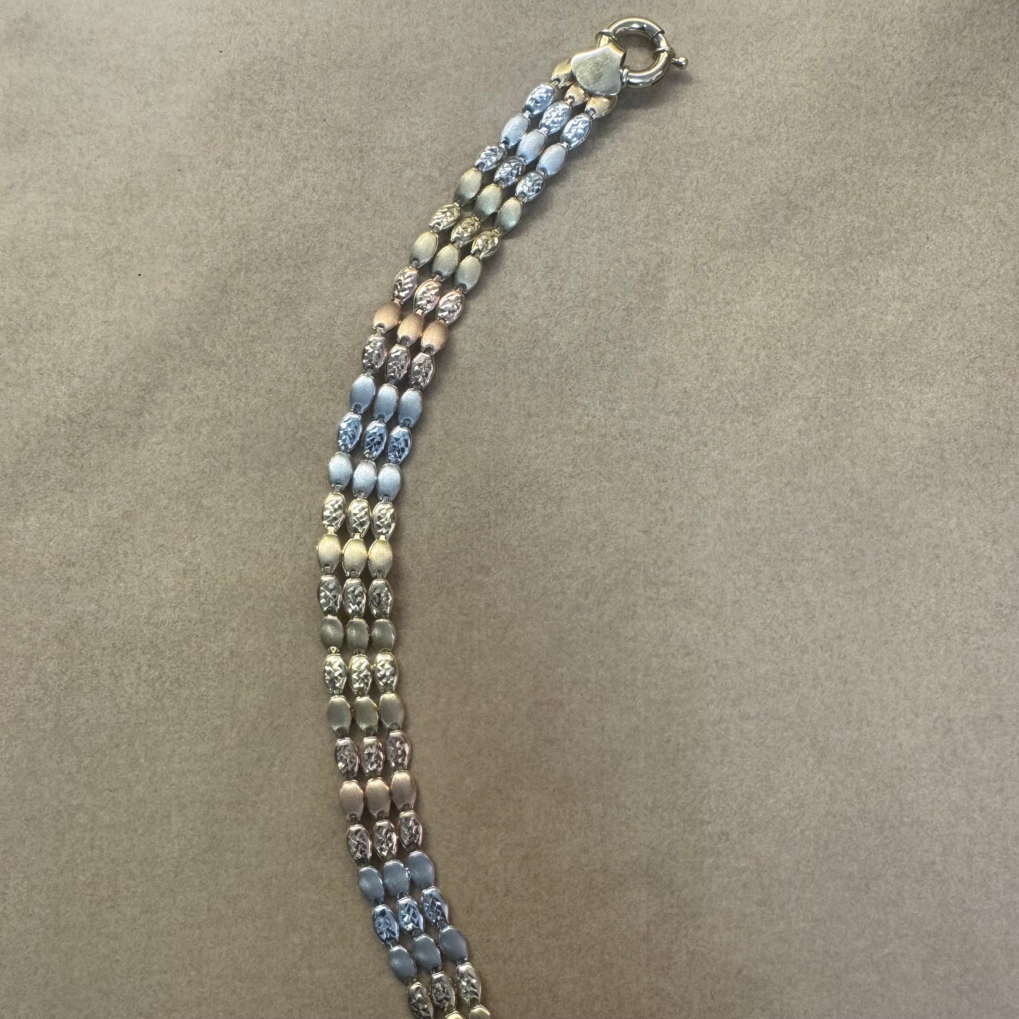 14K tri-color gold bracelet featuring yellow, white and rose gold links