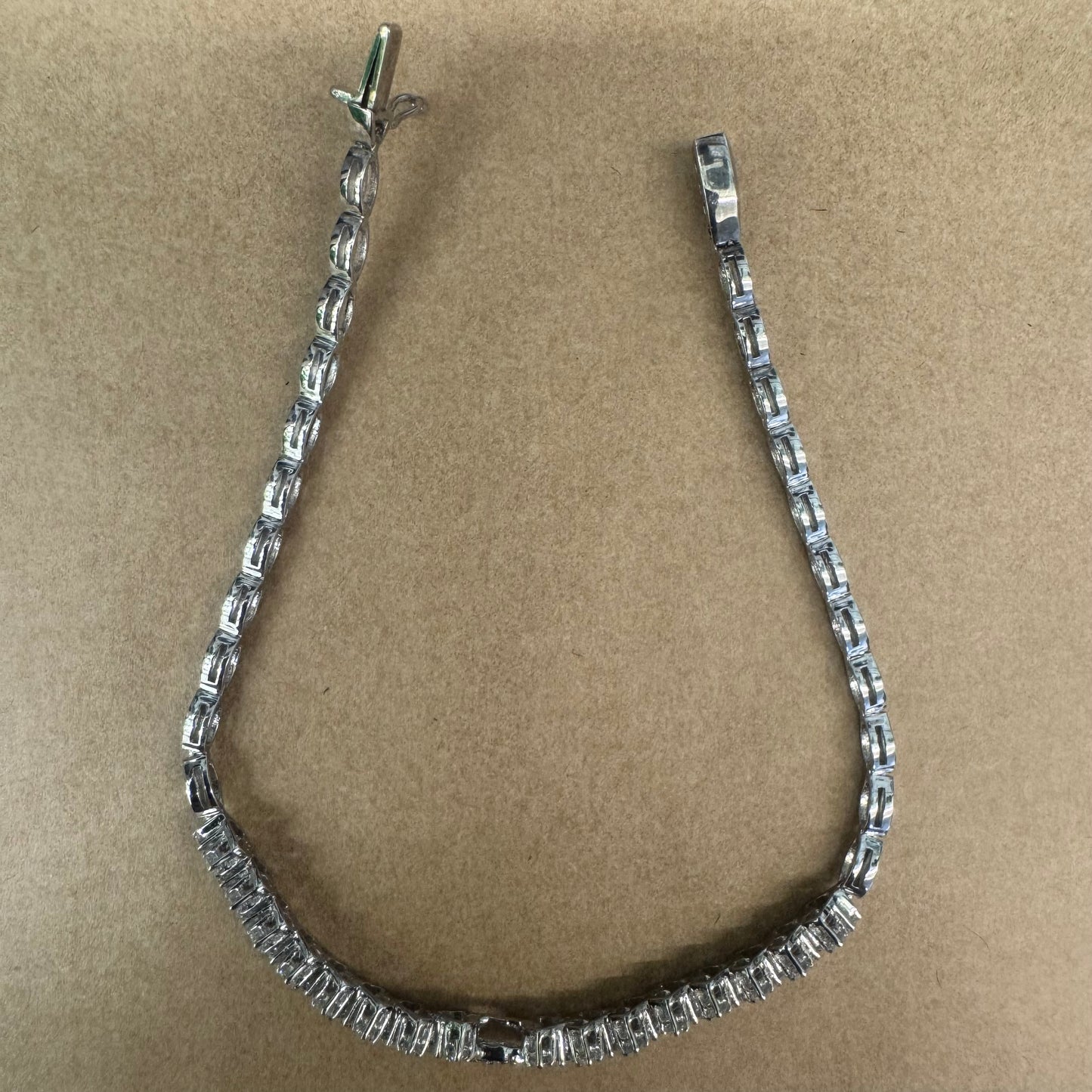 14K white gold bracelet set with sparkling white Diamonds in an elegant floral pattern.