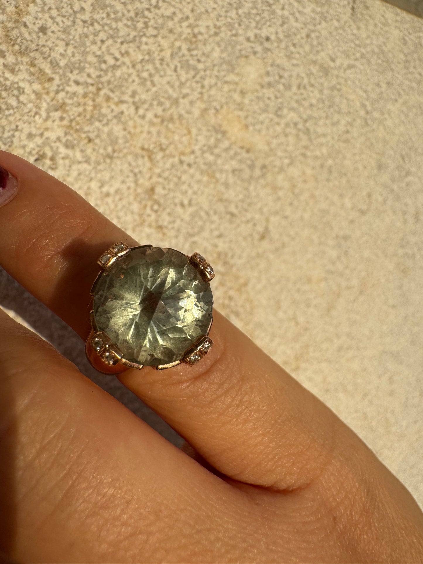 18K gold ring set with a large round Prasiolite gemstone accented by small Diamonds