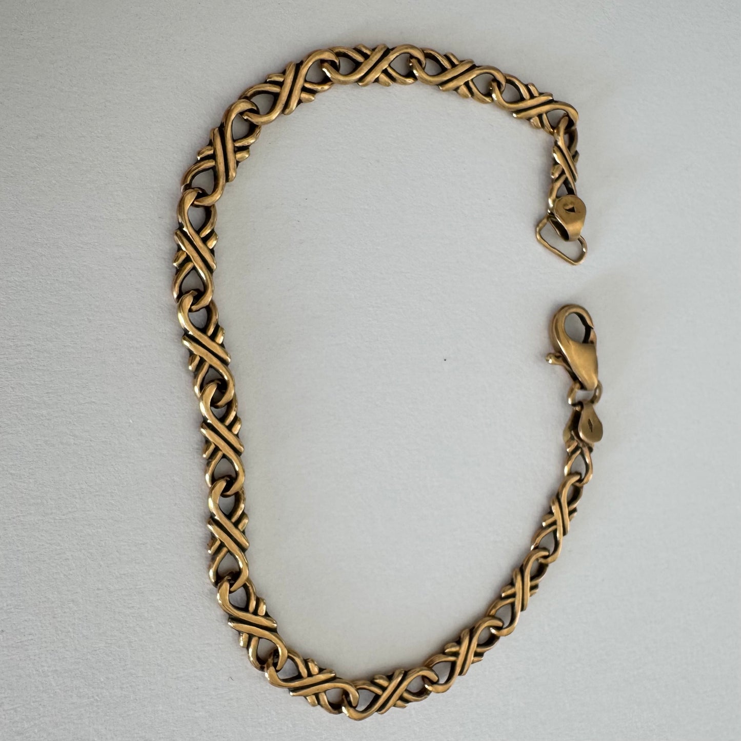 14K gold bracelet with a delicate twisted-link design.
