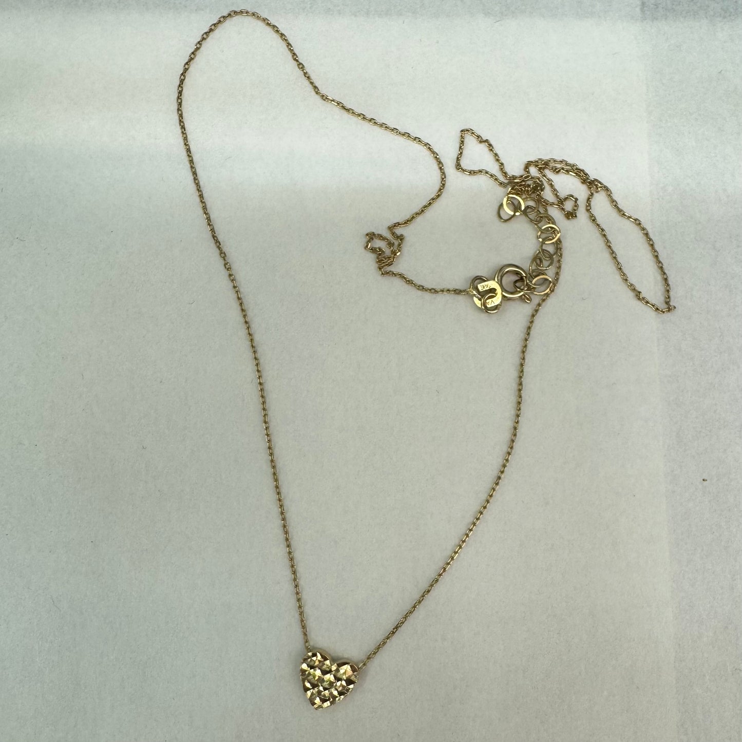 14K gold necklace featuring a heart-shaped pendant with a delicate geometric texture