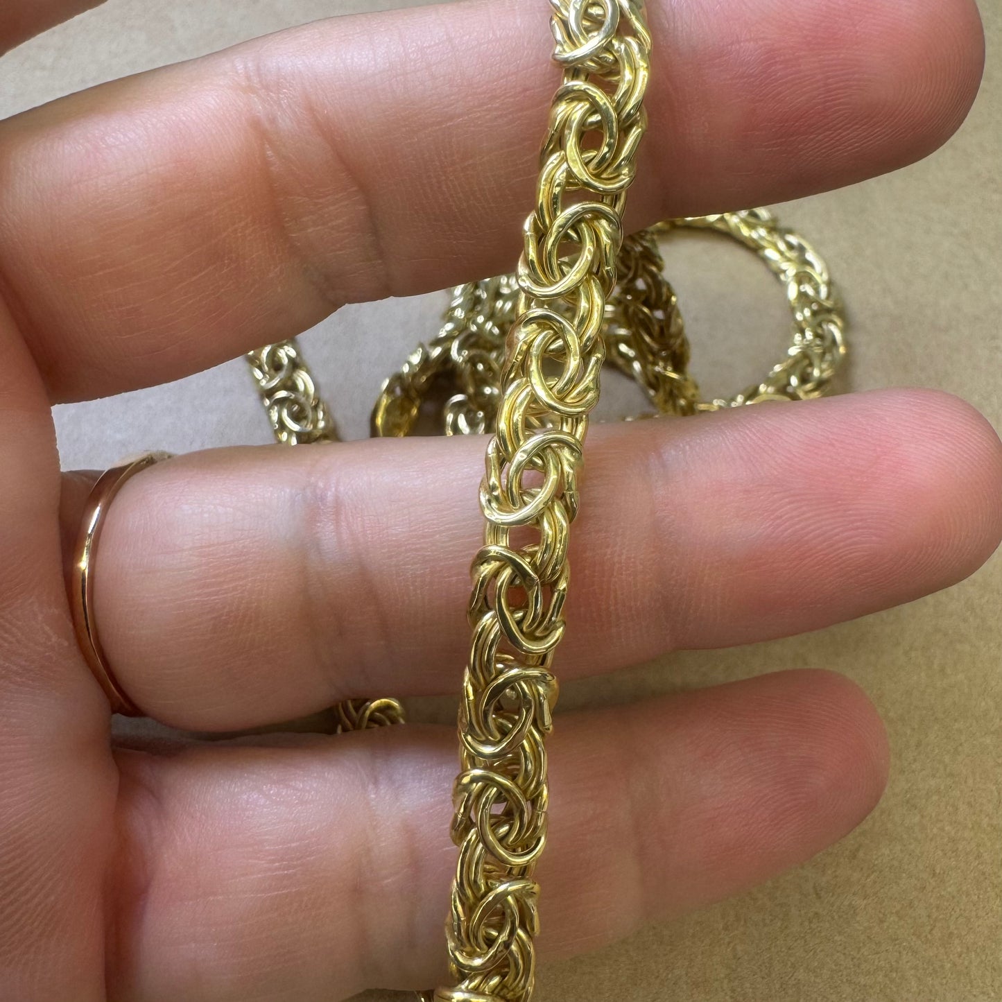 14K yellow gold necklace featuring an intricate, twisted link design