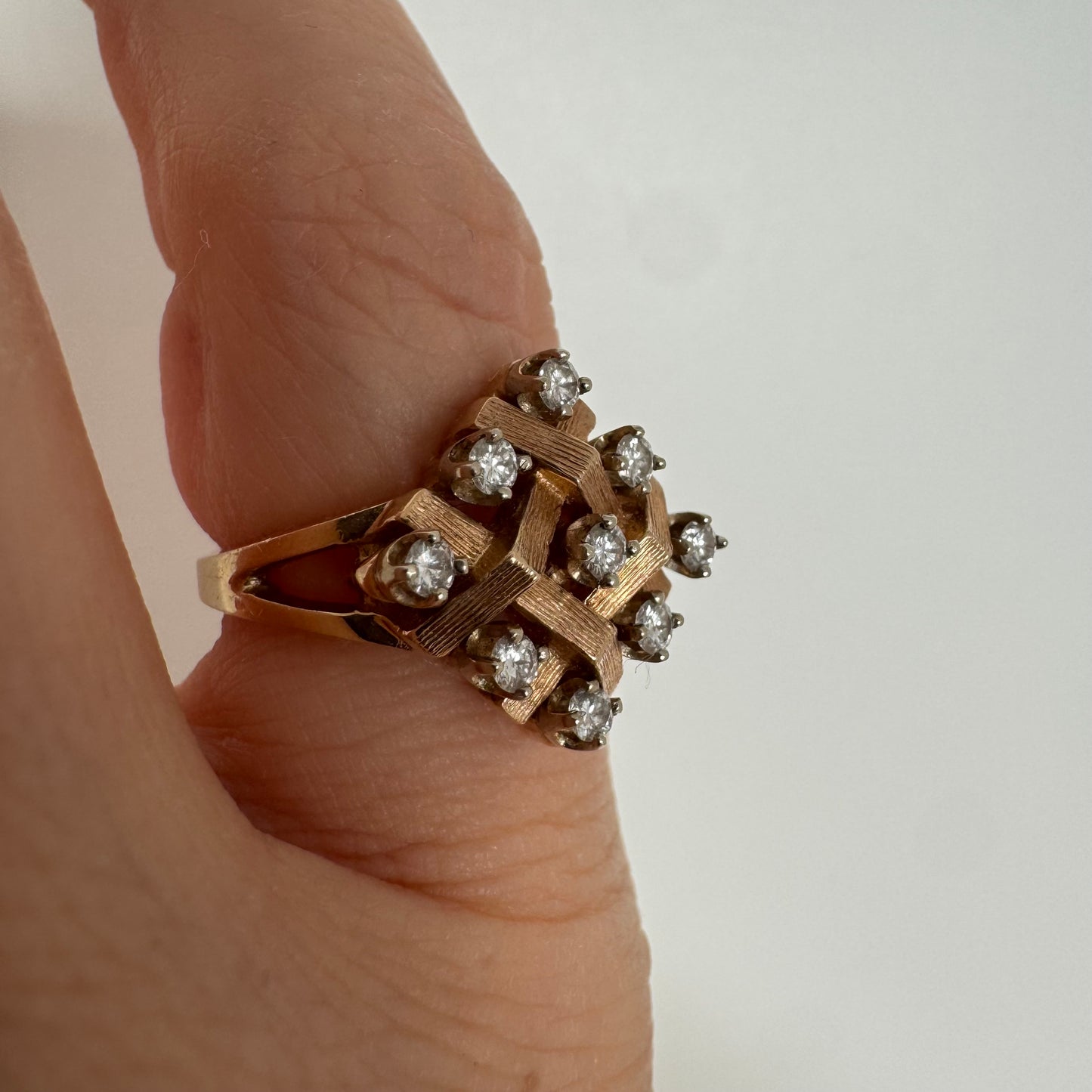 14K gold woven-style ring set with round Diamonds in a symmetrical layout.