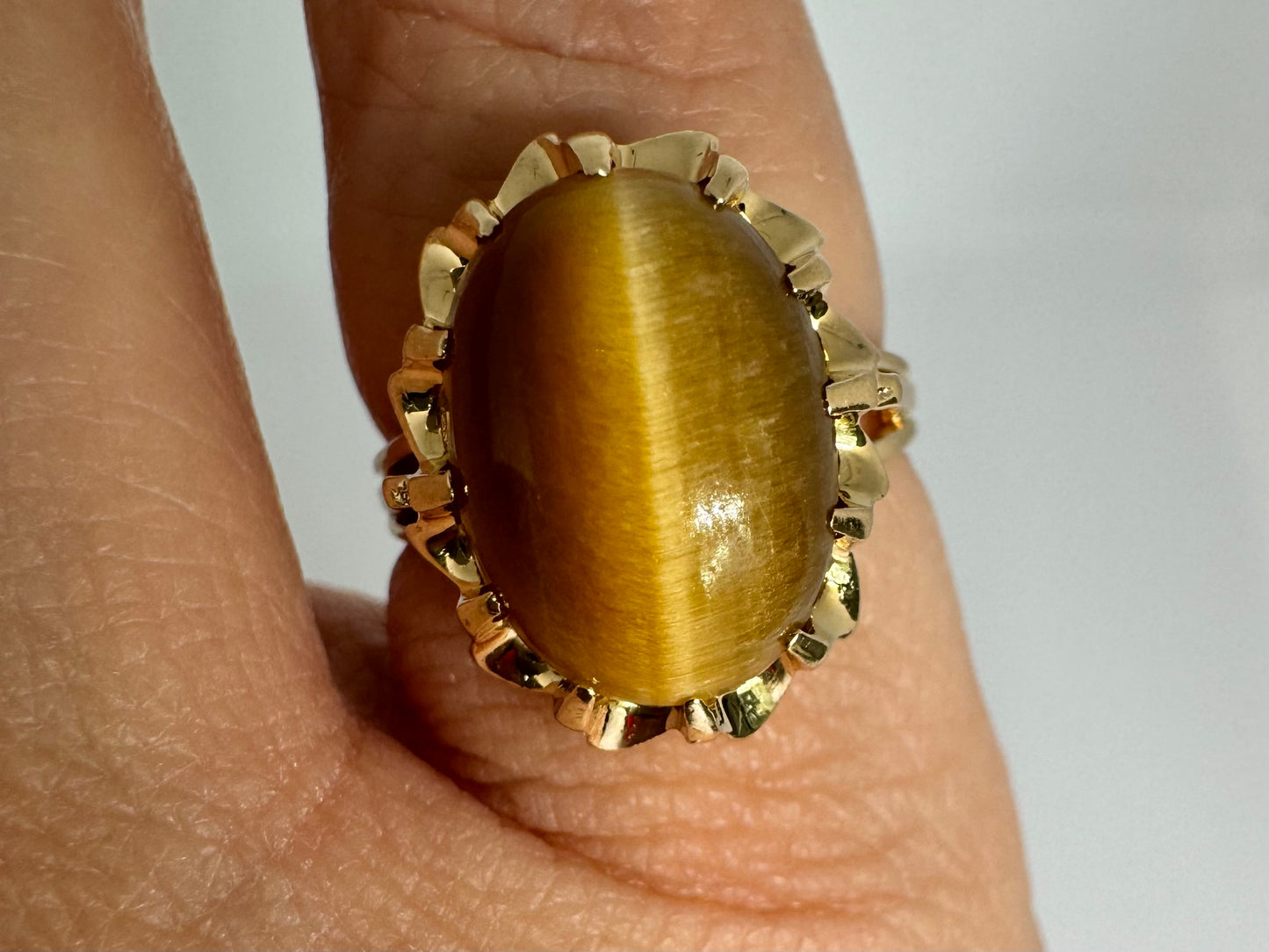 14K gold ring set with a yellow Cat’s Eye cabochon