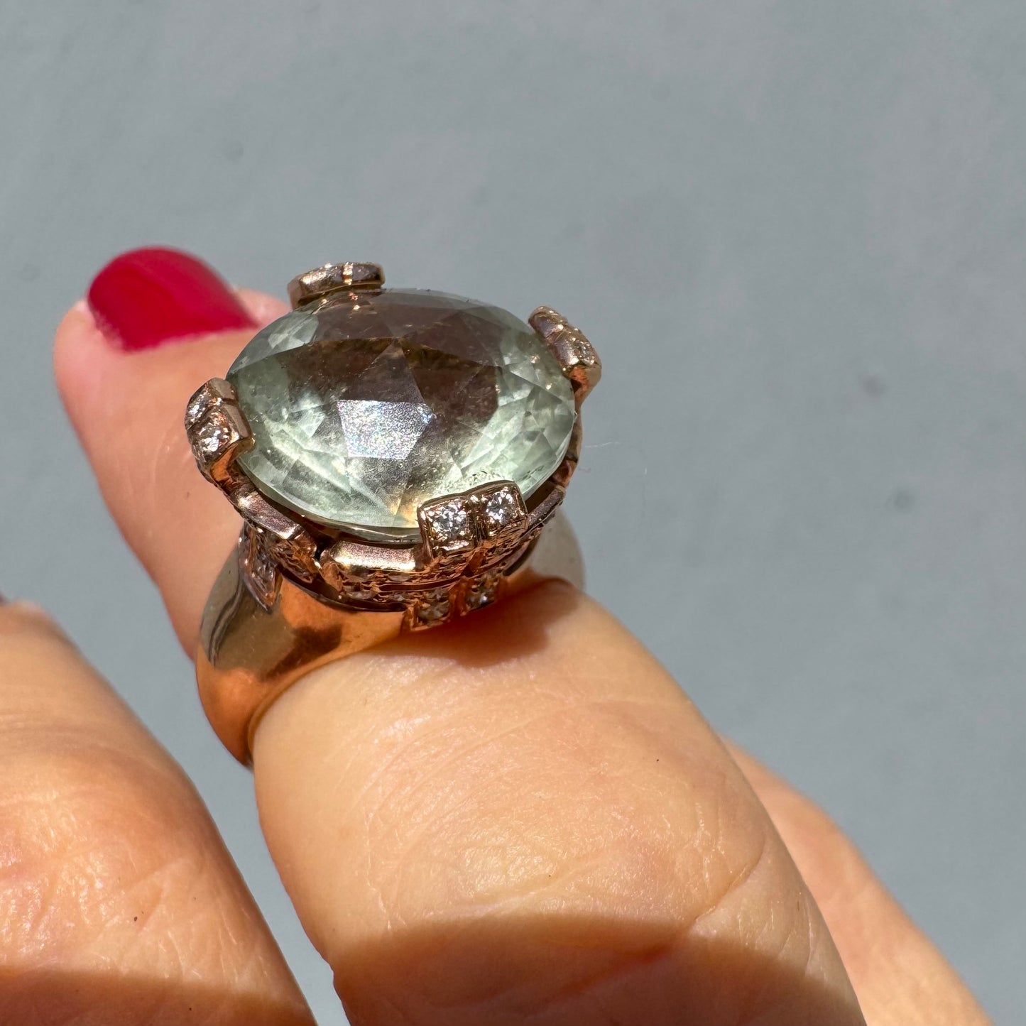 18K gold ring set with a large round Prasiolite gemstone accented by small Diamonds