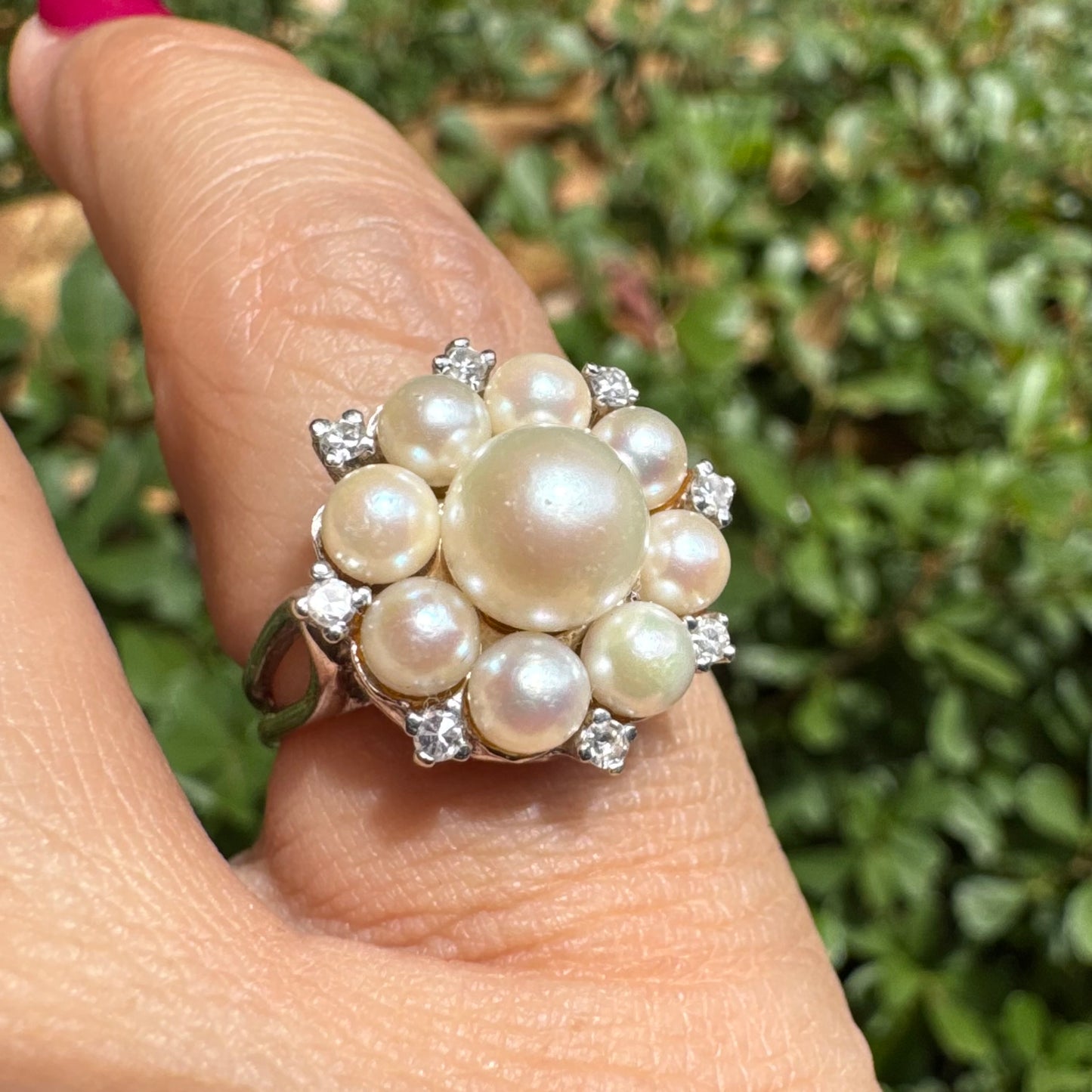 14K gold ring set with a floral cluster of lustrous Pearls in varying sizes, crowned by a central Pearl & surrounded by sparkling Diamond-like accents