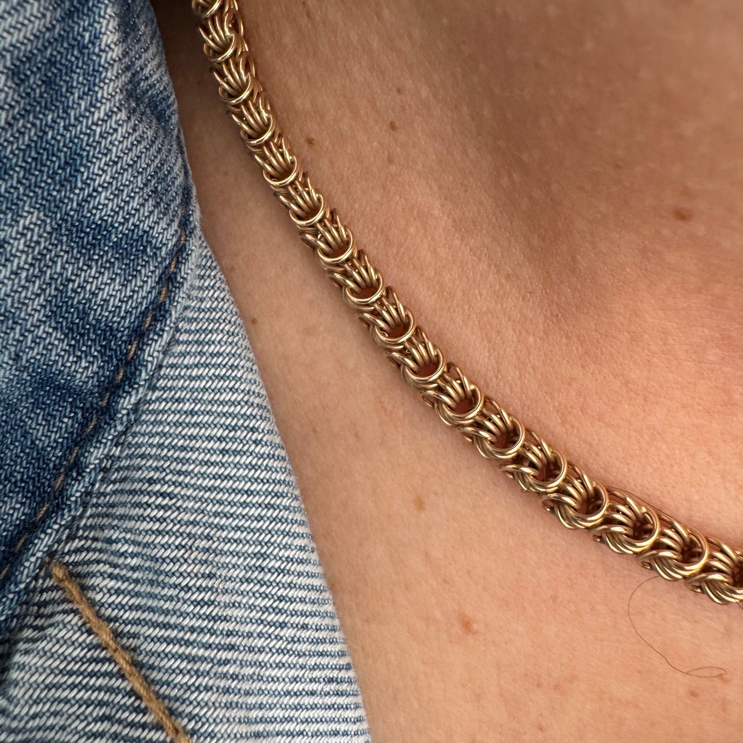 14K gold necklace featuring intricate, interwoven links that create a rich and textured look.
