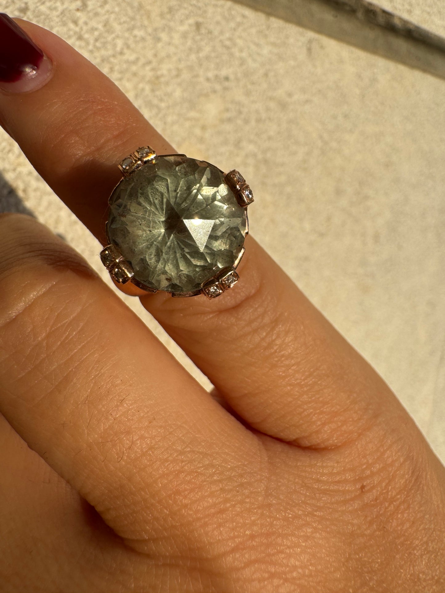 18K gold ring set with a large round Prasiolite gemstone accented by small Diamonds