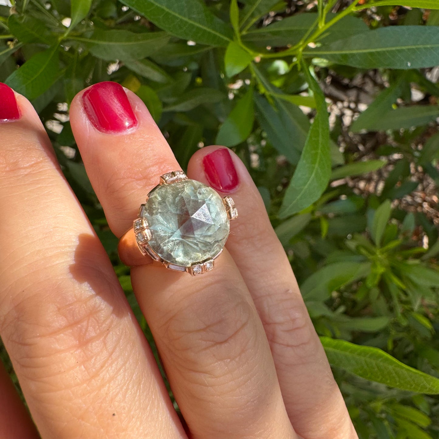 18K gold ring set with a large round Prasiolite gemstone accented by small Diamonds