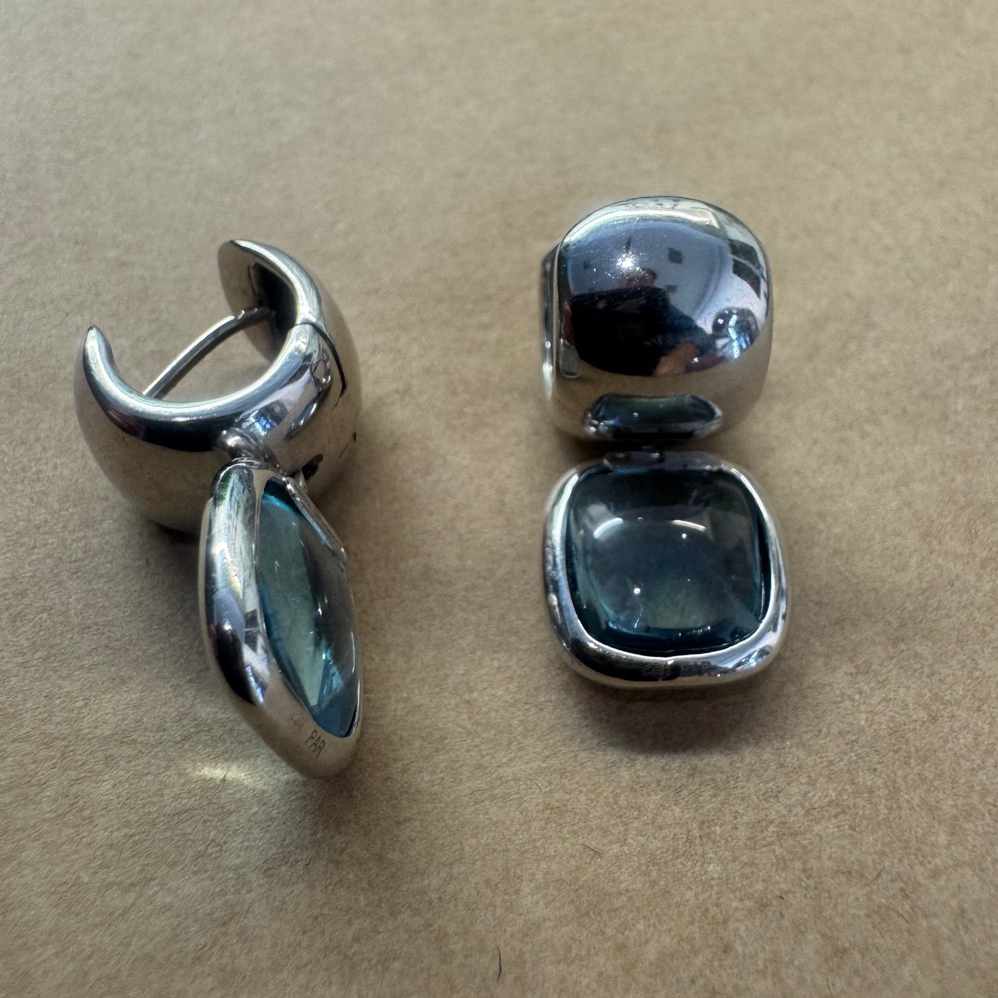 18K gold drop earrings featuring cushion-shaped Aquamarine in a smooth bezel setting, with a polished, modern design.