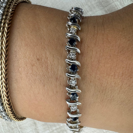 14K gold bracelet set with alternating deep blue Sapphires and sparkling Diamonds