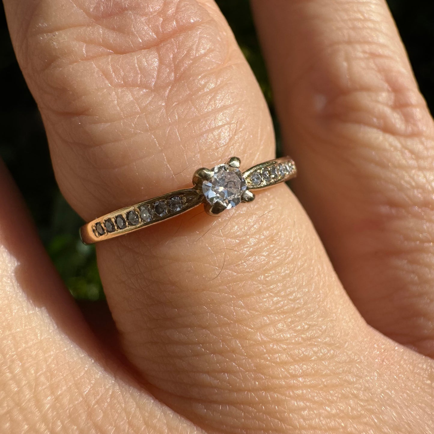 14K gold ring set with one center Diamond and side Diamonds