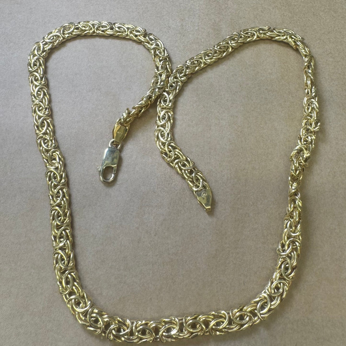 14K yellow gold necklace featuring an intricate, twisted link design