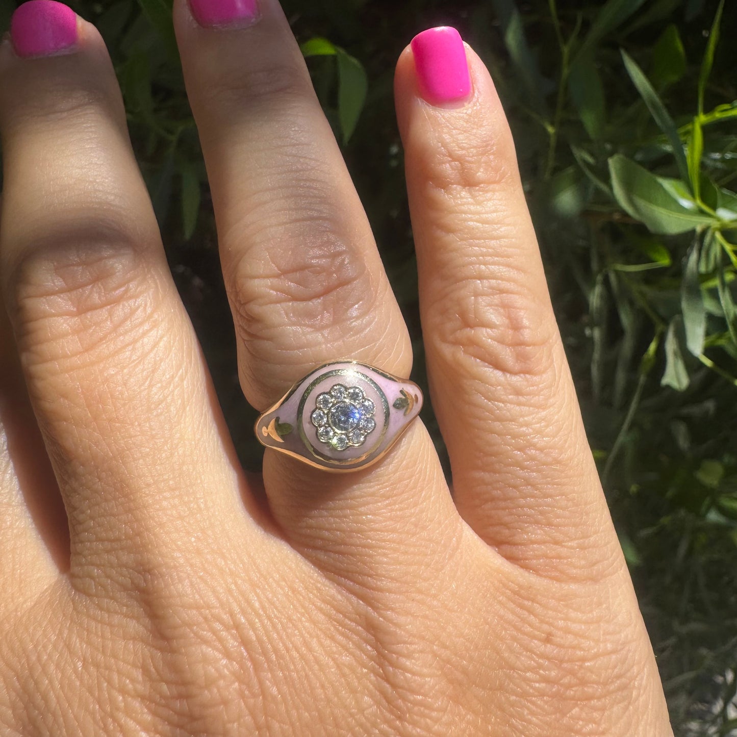 14K gold ring set with soft pink enamel & Diamonds with floral motif at the center.