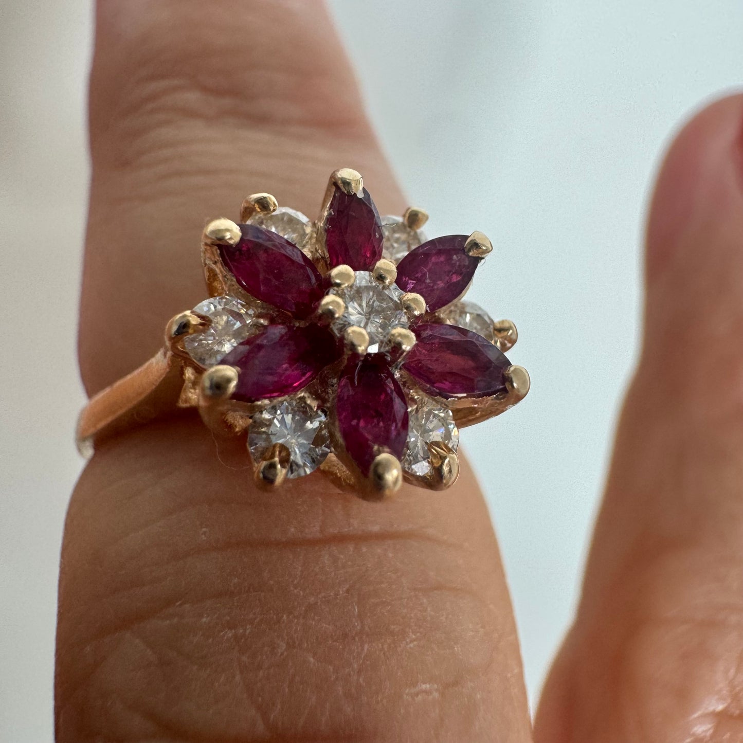 14K gold ring featuring a classic floral-inspired design set with marquise-cut Rubies & Diamonds.