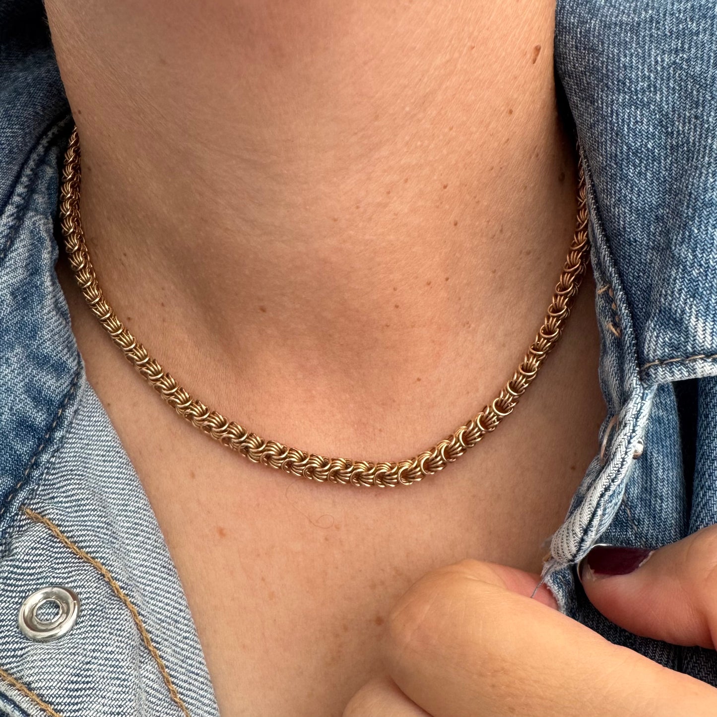 14K gold necklace featuring intricate, interwoven links that create a rich and textured look.