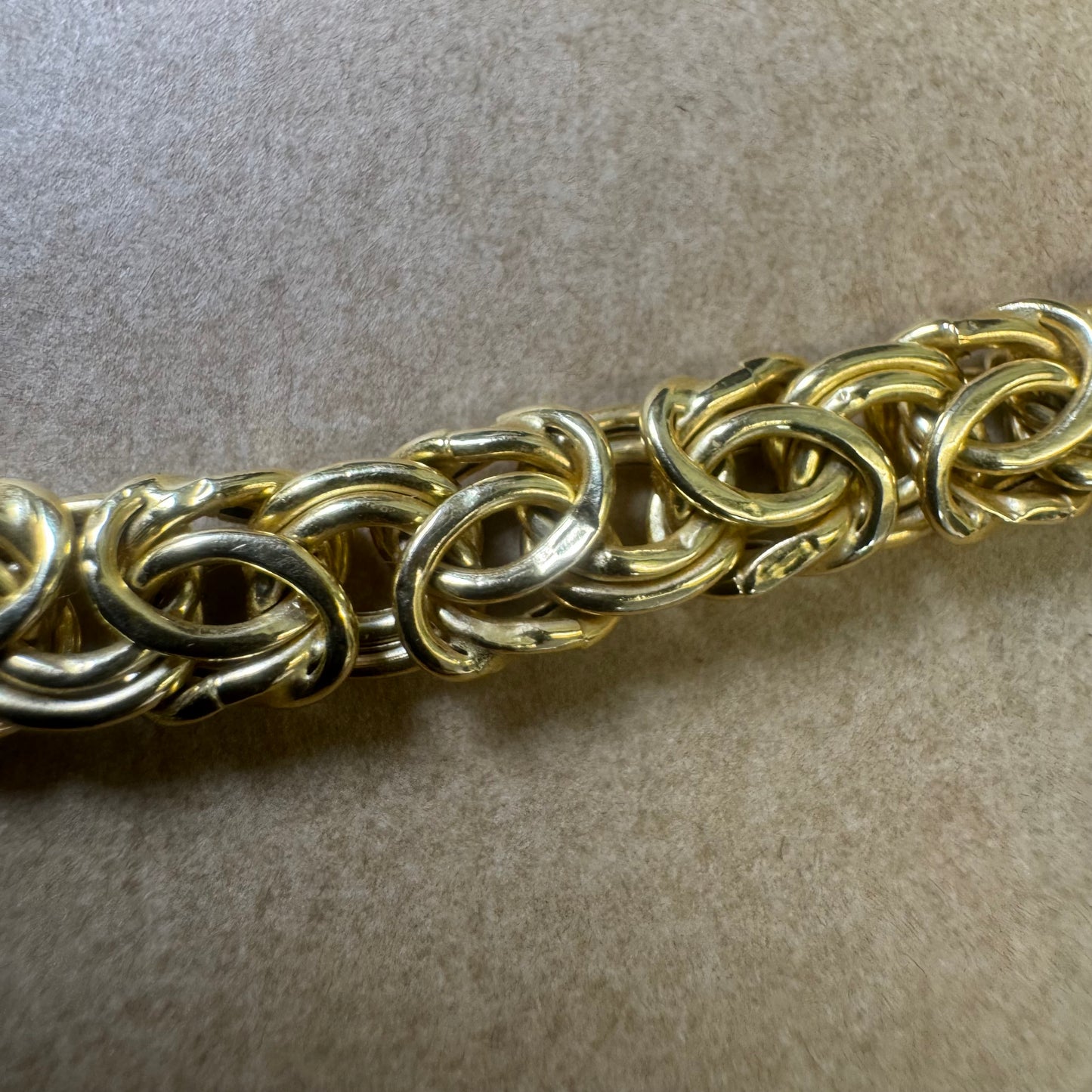 14K yellow gold necklace featuring an intricate, twisted link design