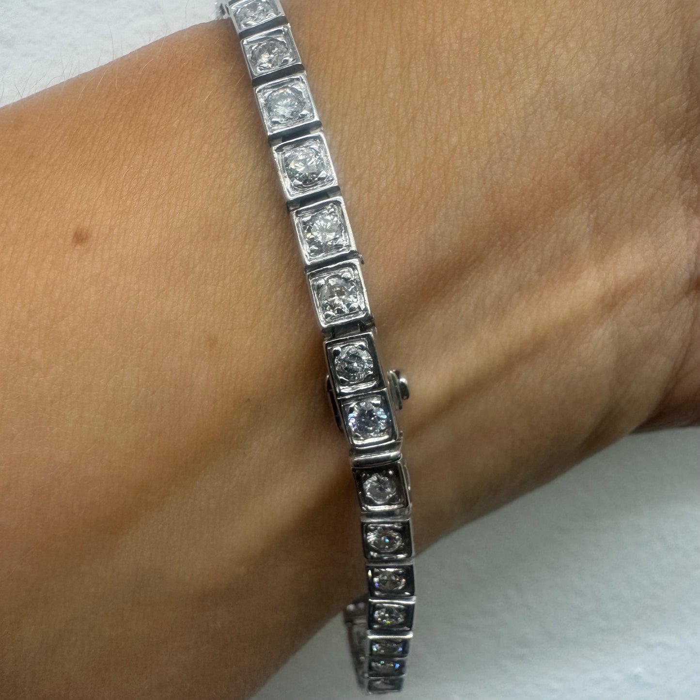 18K gold tennis bracelet set with sparkling round-cut Diamonds in square bezel settings, creating a timeless and sophisticated look.