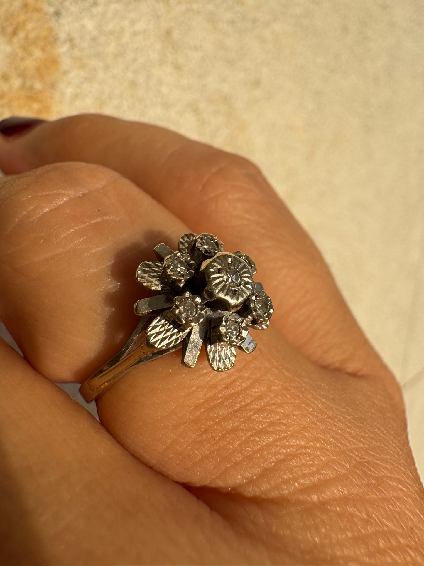 18K gold floral ring adorned with delicate diamond accents