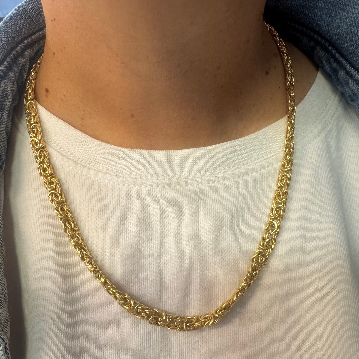14K yellow gold necklace featuring an intricate, twisted link design