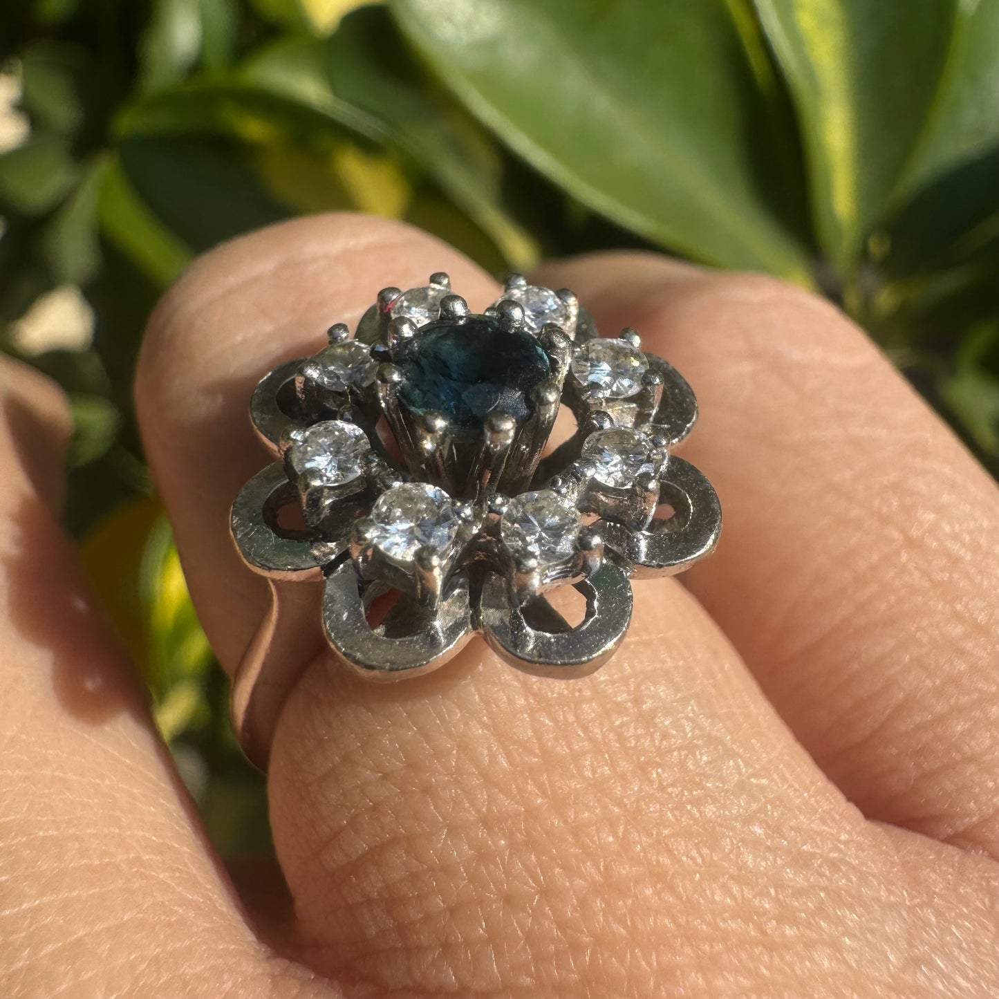 14K gold floral ring set with a round deep blue Sapphire at its center & Diamonds