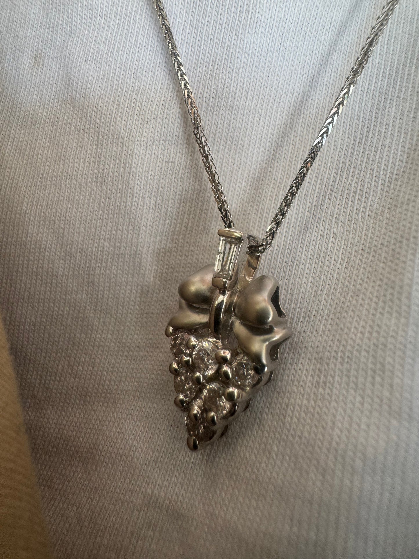 18K gold pendant, crafted in a timeless grape cluster design and set with sparkling diamonds.