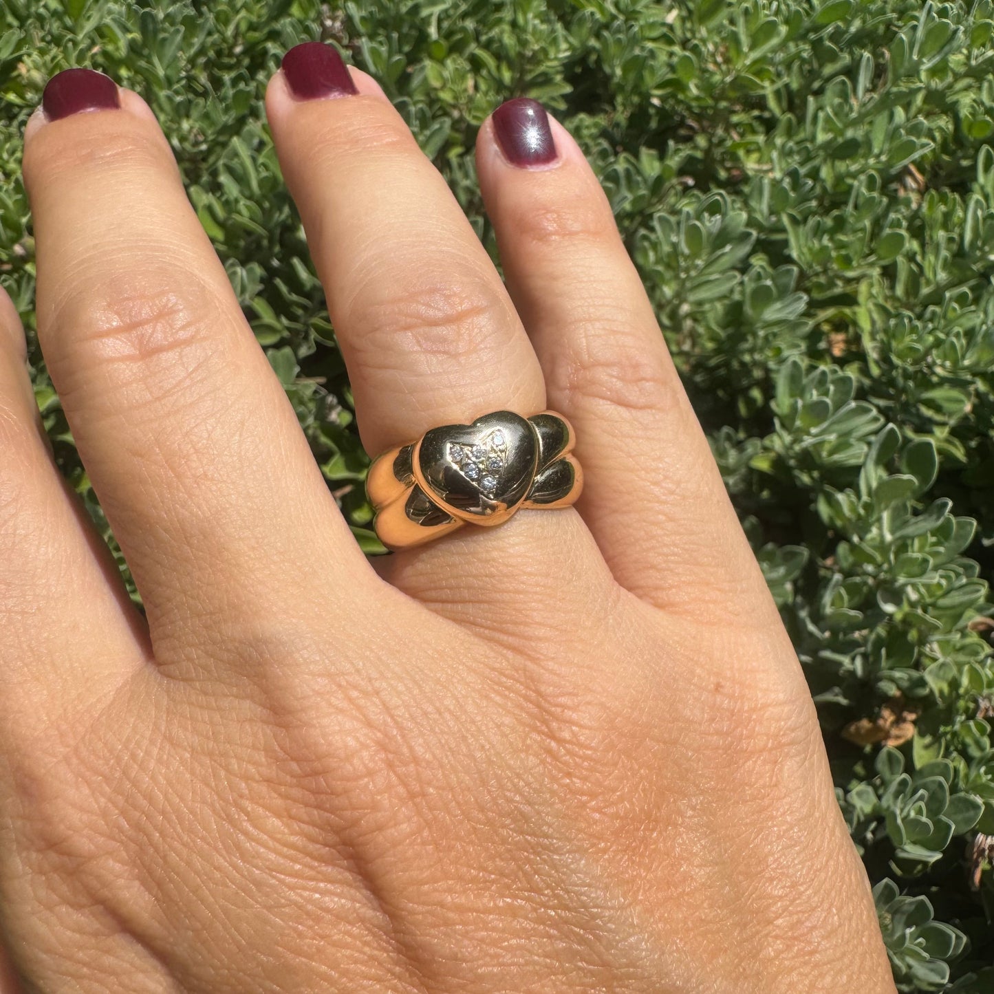 18K gold ring featuring a bold heart design, set with sparkling Diamonds in the center.