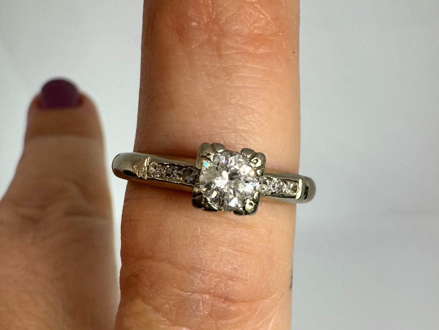 טבעת זהב לבן 14 קראט משובצת יהלום מרכזי ויהלומים בצדדים