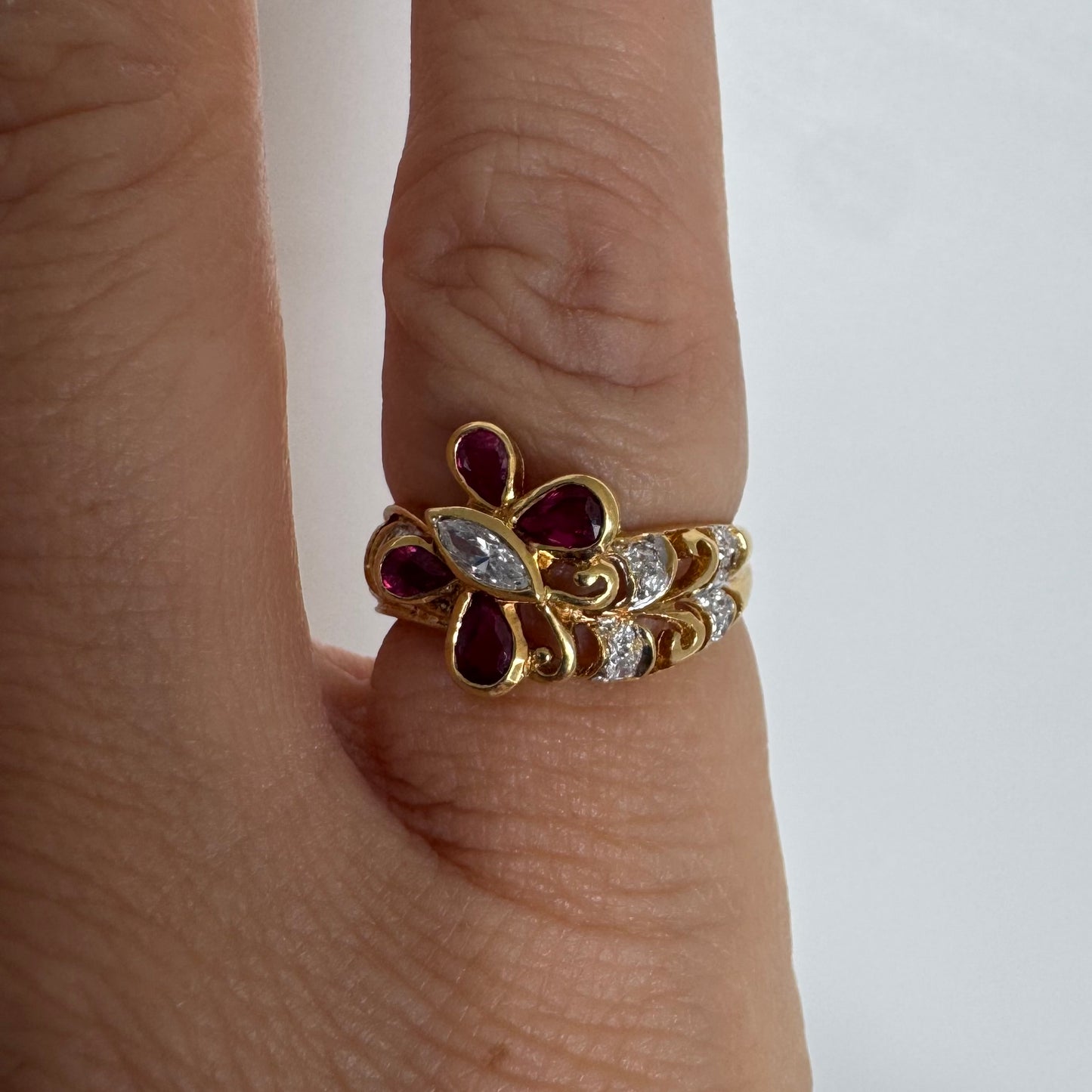 18K gold butterfly ring set with pear-cut Rubies & a marquise-cut Diamond at its center