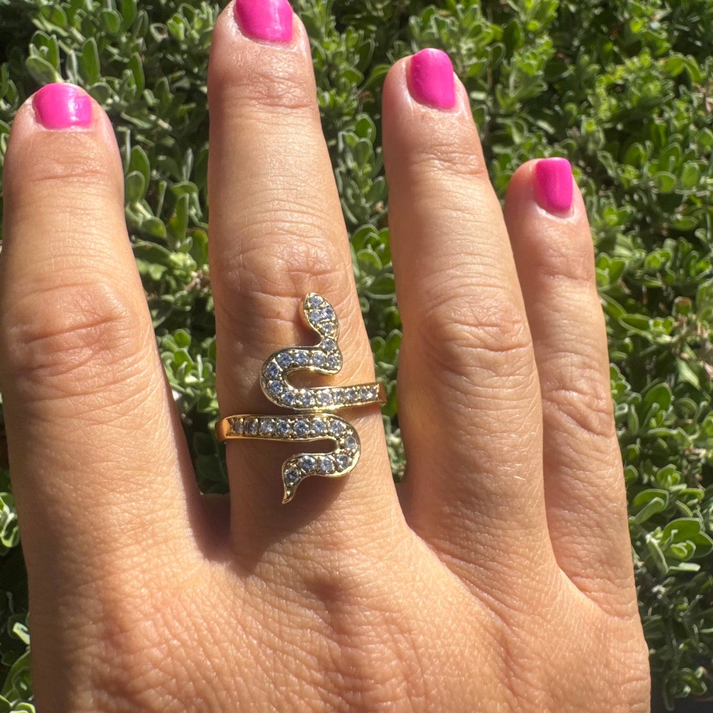 18K gold snake ring adorned with sparkling Diamonds, elegantly wrapping around the finger.