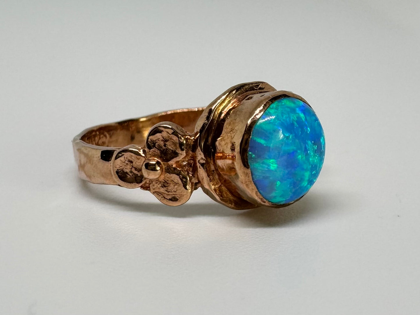 10K gold ring set with round Opal with vibrant flashes of blue, green and white