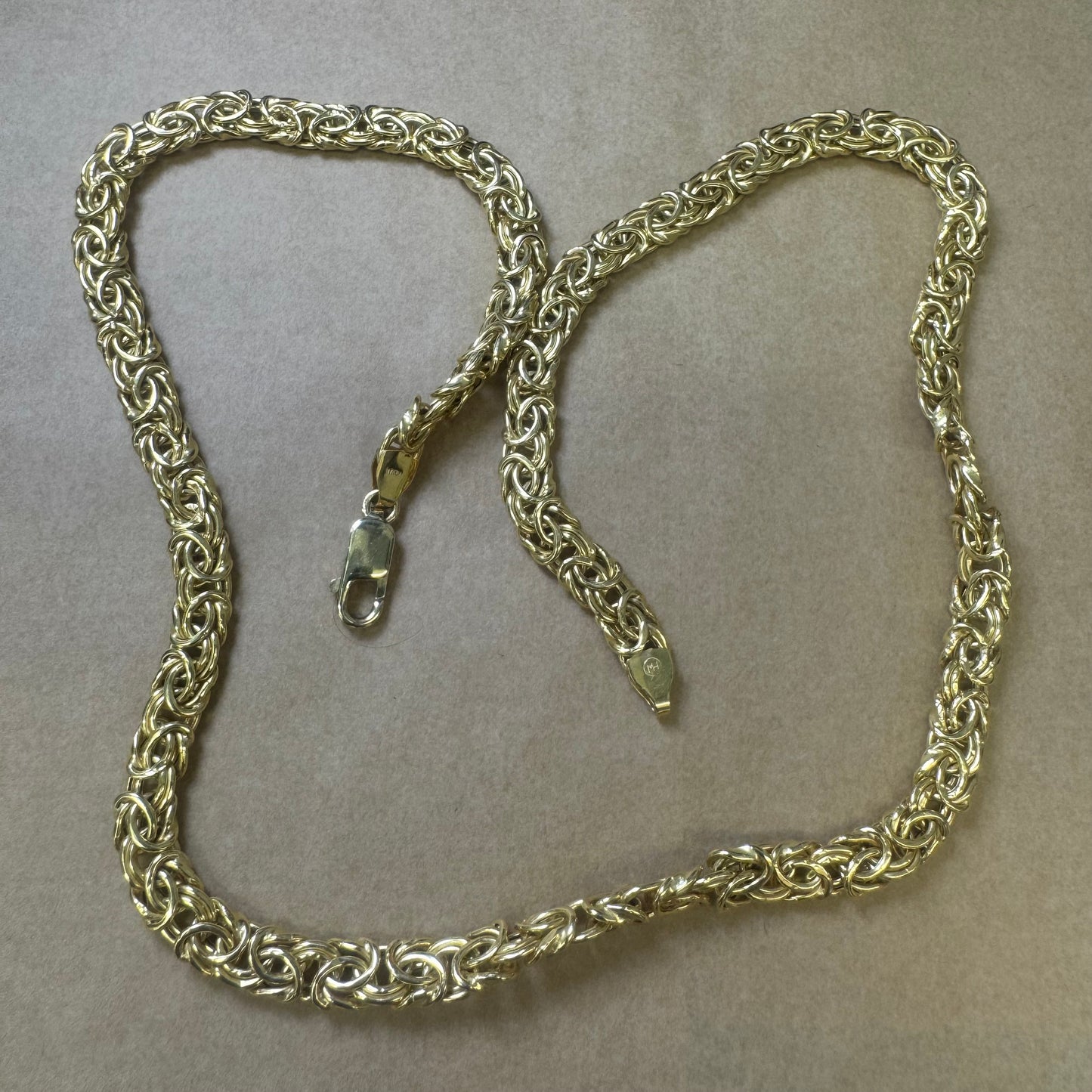 14K yellow gold necklace featuring an intricate, twisted link design