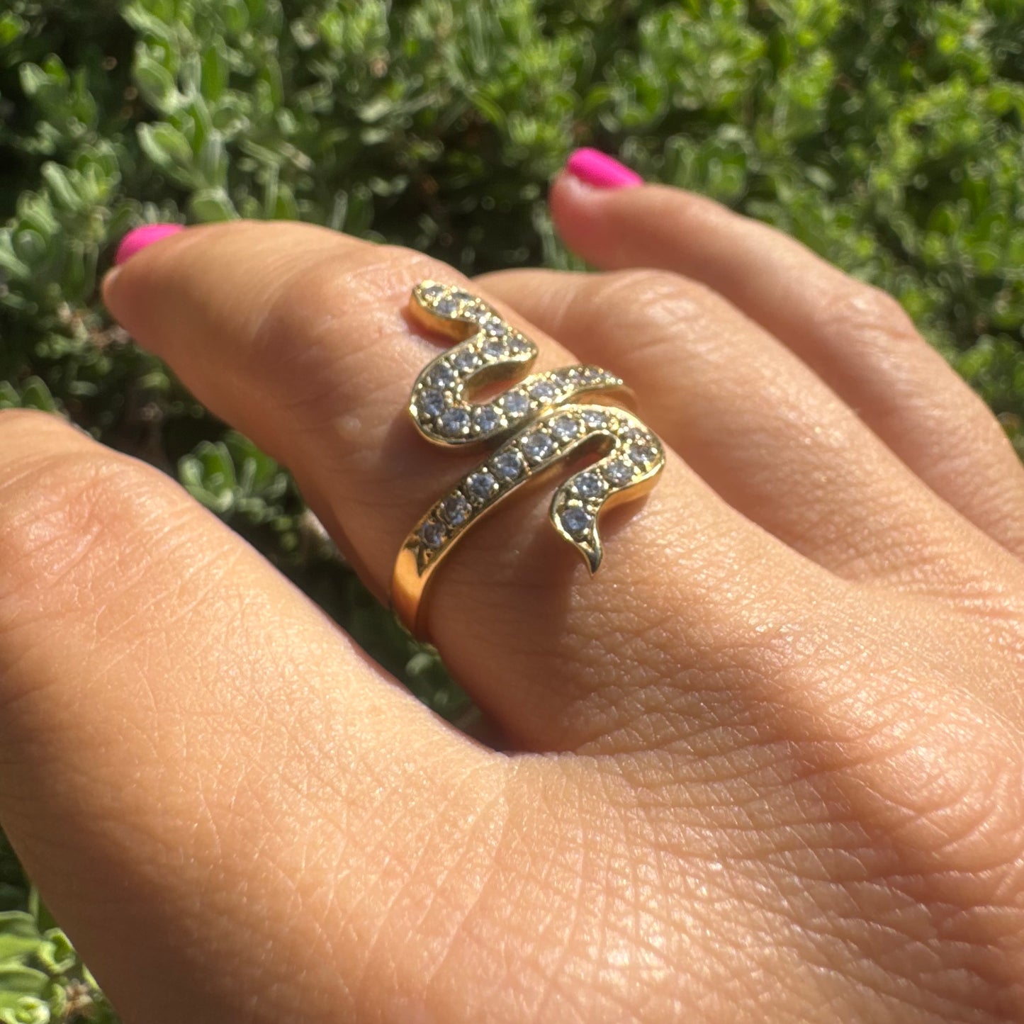 18K gold snake ring adorned with sparkling Diamonds, elegantly wrapping around the finger.