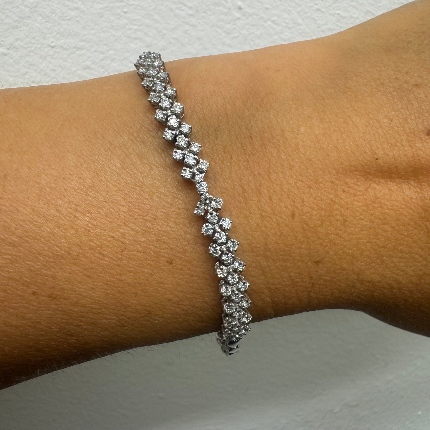 14K white gold bracelet set with sparkling white Diamonds in an elegant floral pattern.