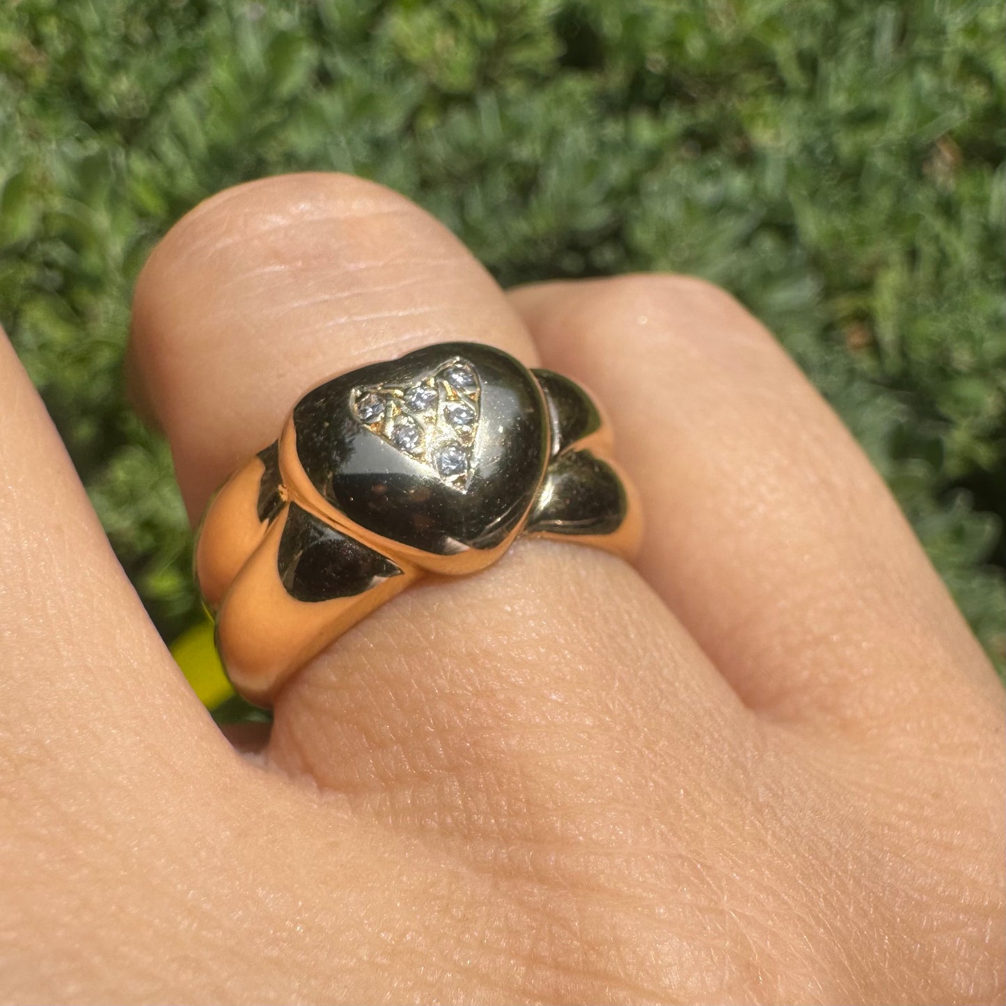 18K gold ring featuring a bold heart design, set with sparkling Diamonds in the center.