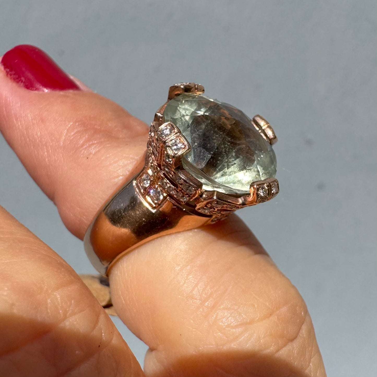 18K gold ring set with a large round Prasiolite gemstone accented by small Diamonds