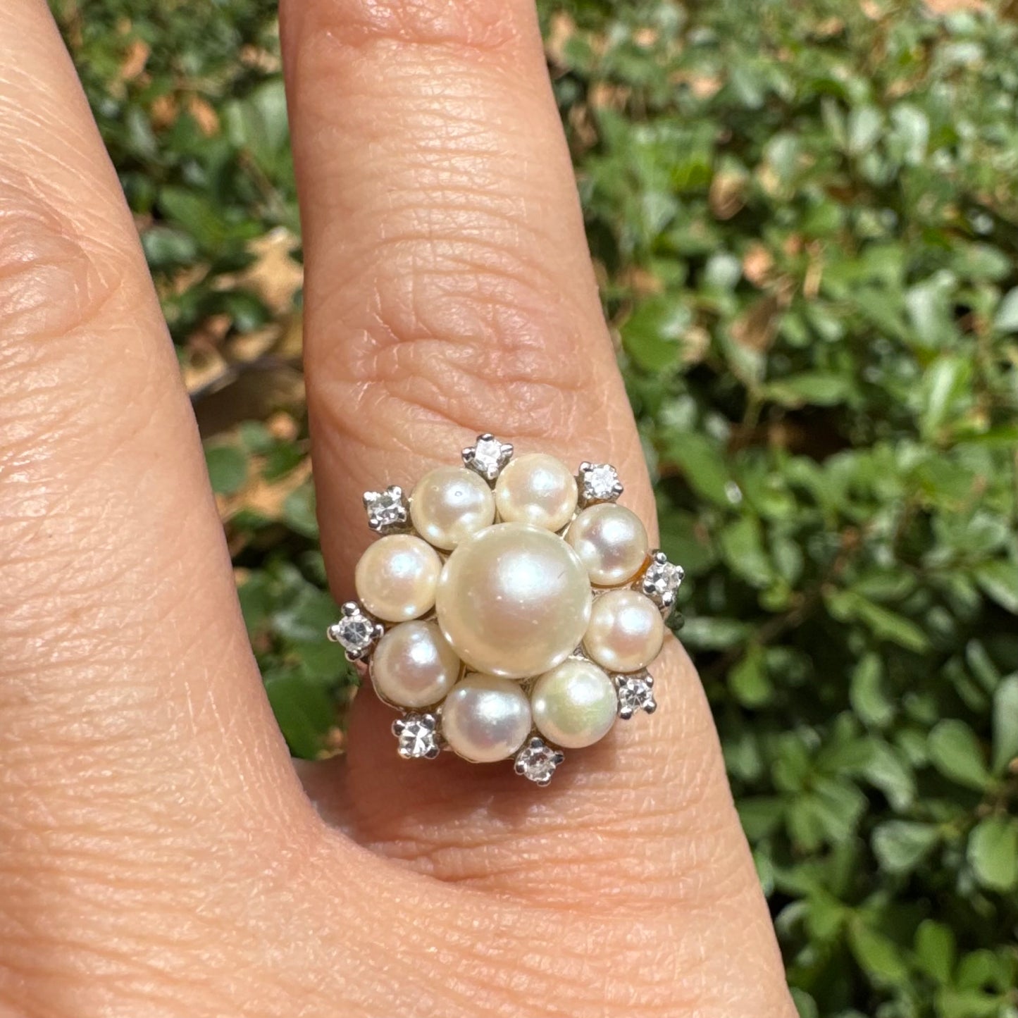 14K gold ring set with a floral cluster of lustrous Pearls in varying sizes, crowned by a central Pearl & surrounded by sparkling Diamond-like accents