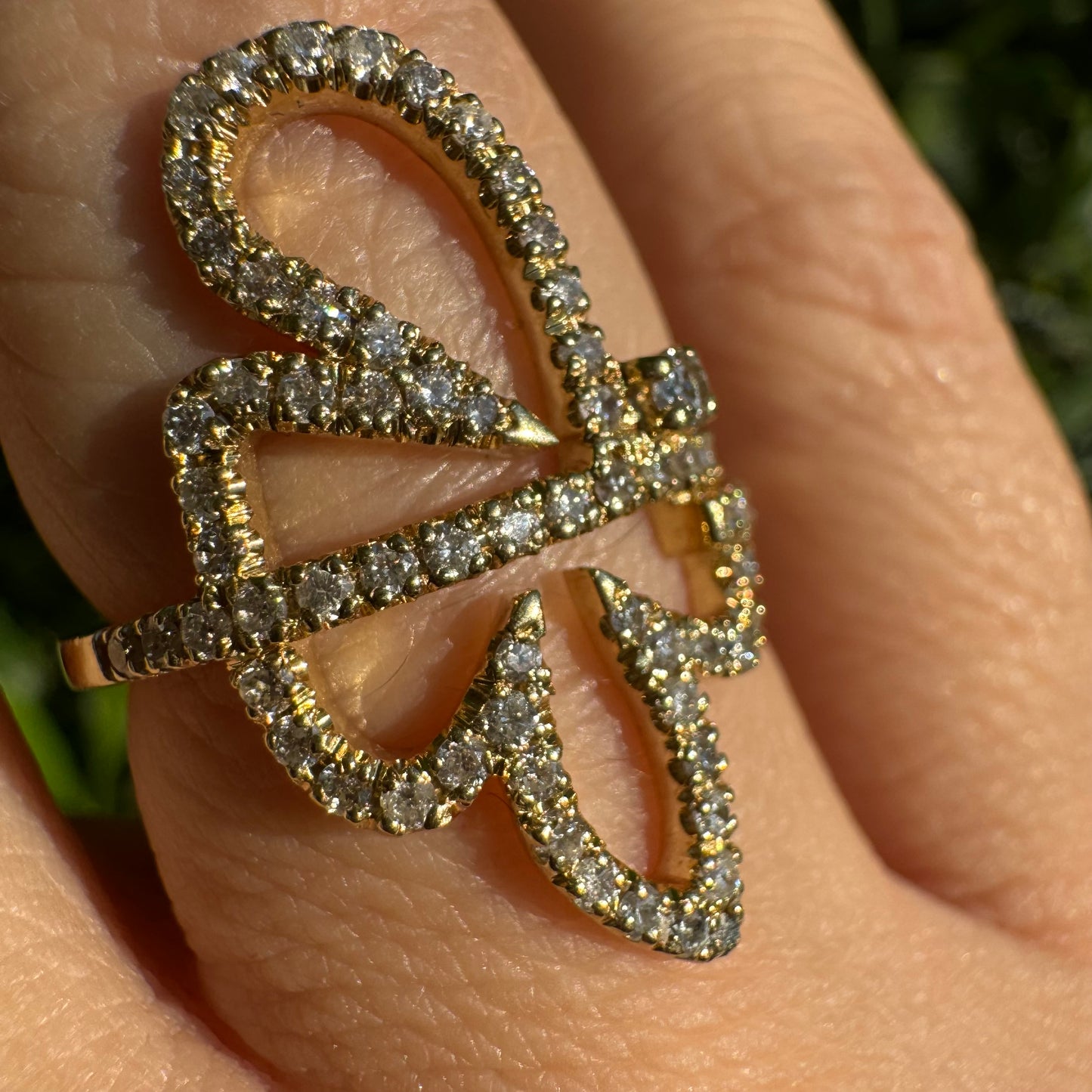 טבעת זהב צהוב 14 קראט בעיצוב פרפר פתוח, מעוטרת במסגרת יהלומים נוצצים למראה עדין ובולט.