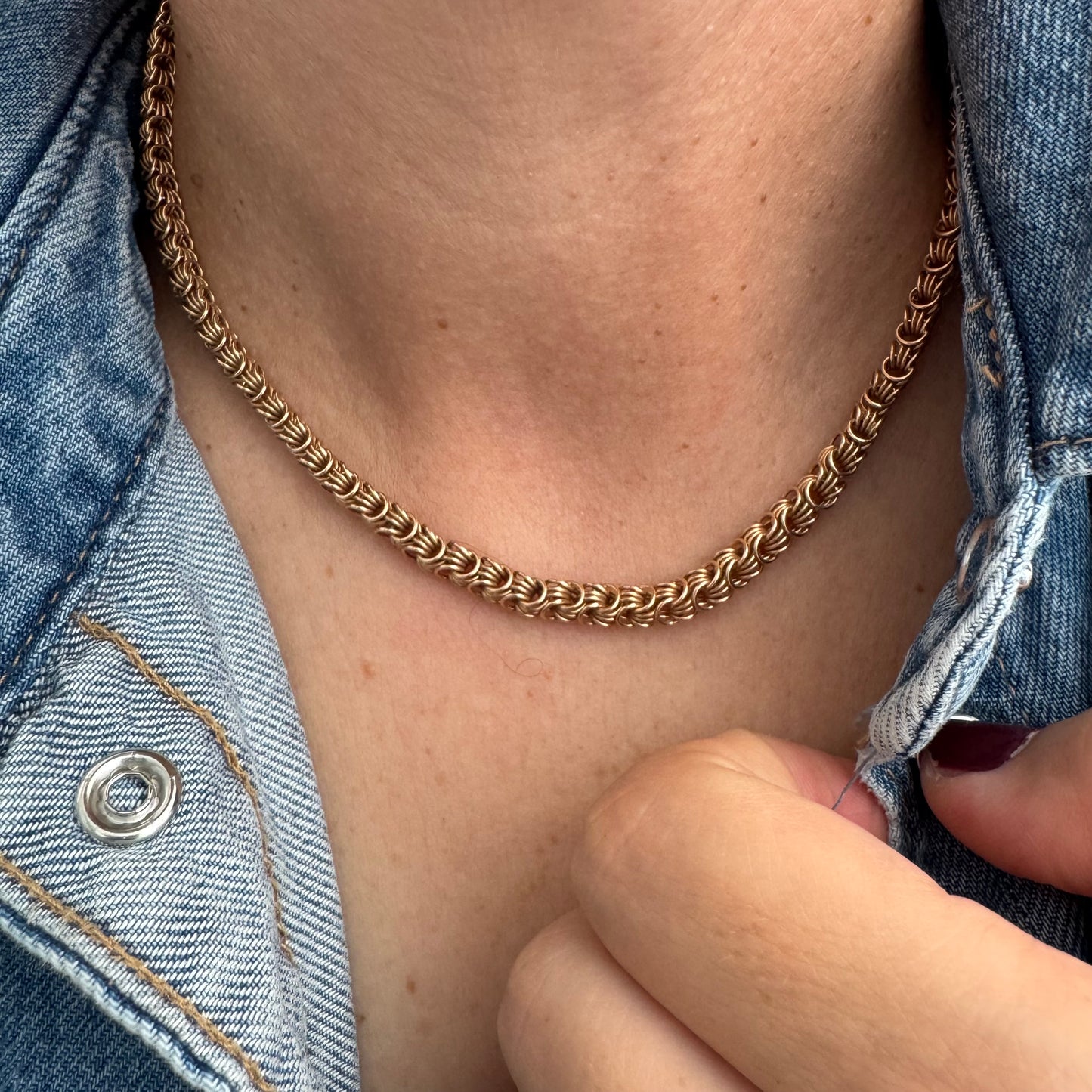 14K gold necklace featuring intricate, interwoven links that create a rich and textured look.