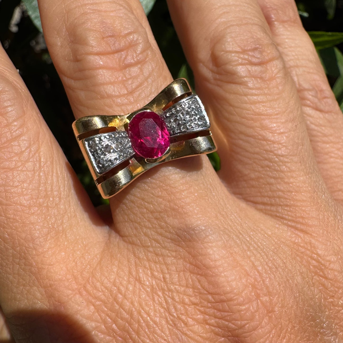 18K gold ring in a sculptural bow-inspired design.
Set with a vivid oval-cut Ruby at the center, framed by shimmering Diamonds