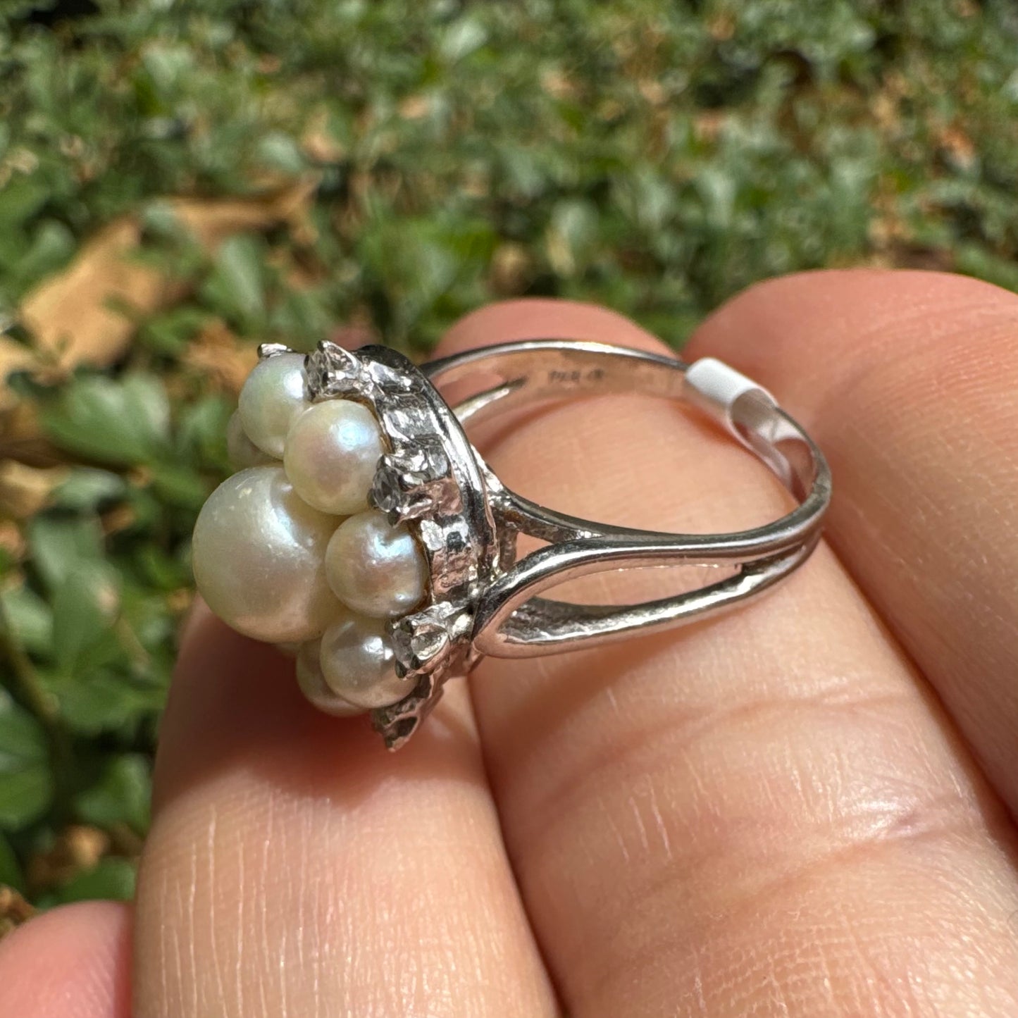14K gold ring set with a floral cluster of lustrous Pearls in varying sizes, crowned by a central Pearl & surrounded by sparkling Diamond-like accents