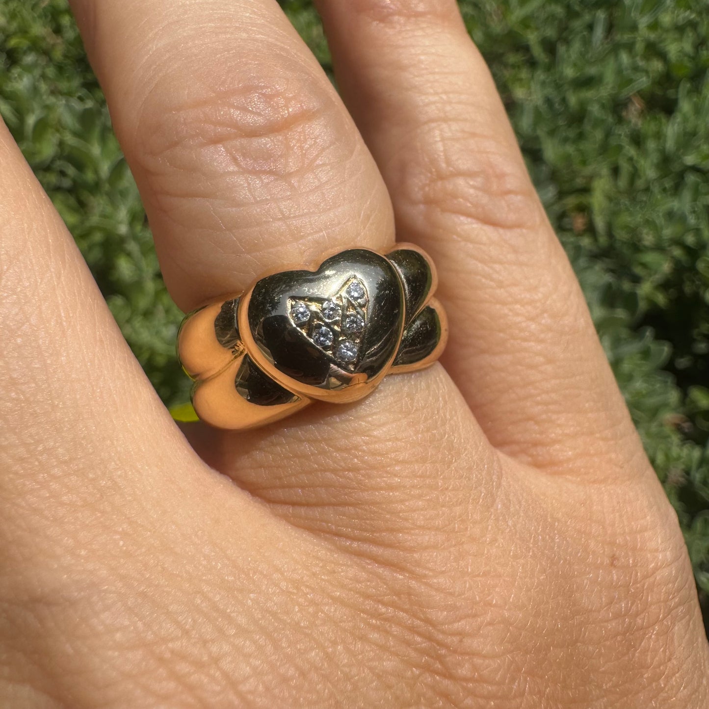 18K gold ring featuring a bold heart design, set with sparkling Diamonds in the center.