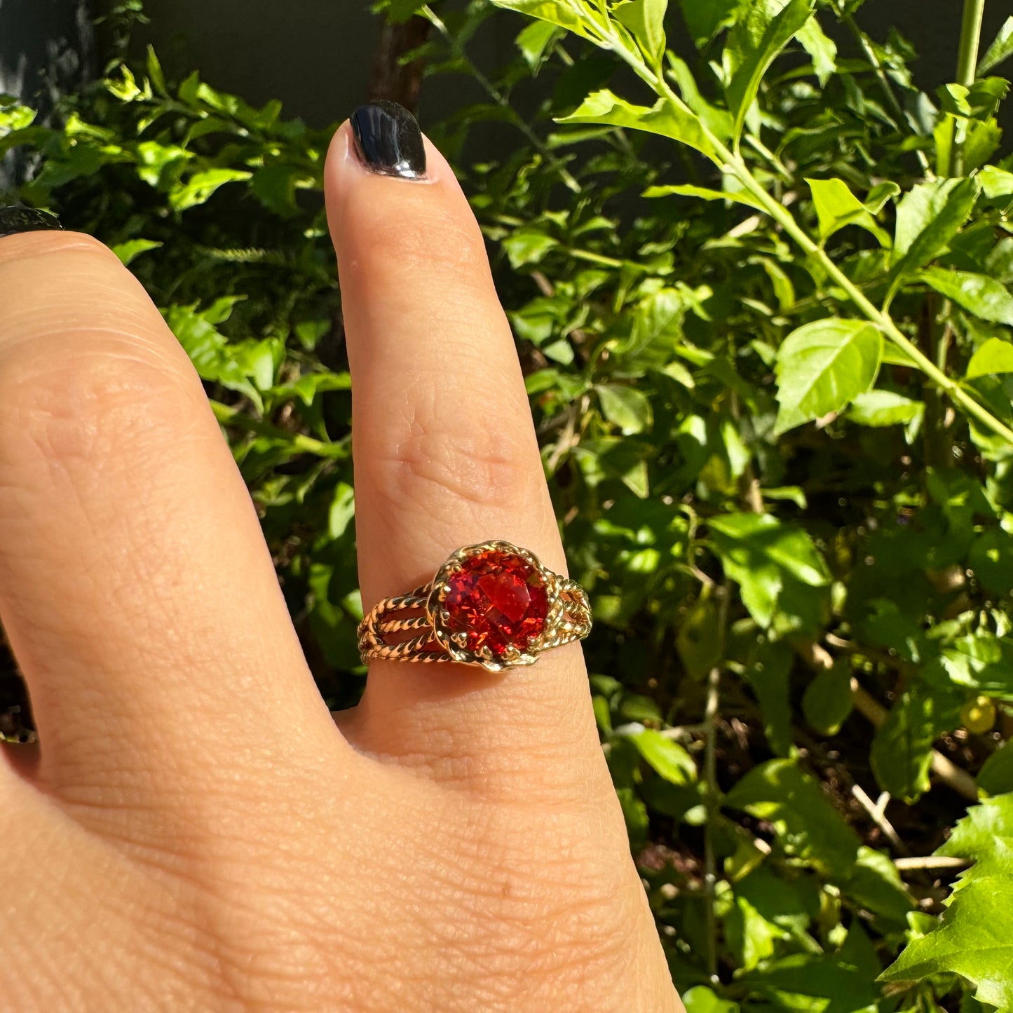 10K gold ring set with a vivid orange gemstone