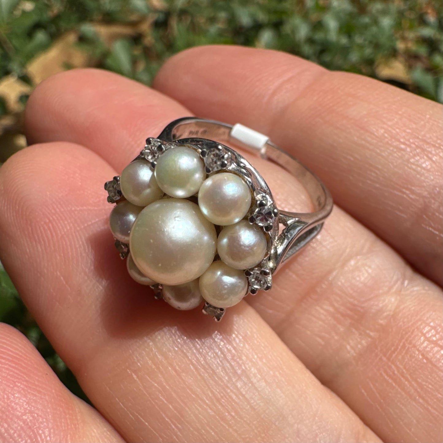 14K gold ring set with a floral cluster of lustrous Pearls in varying sizes, crowned by a central Pearl & surrounded by sparkling Diamond-like accents