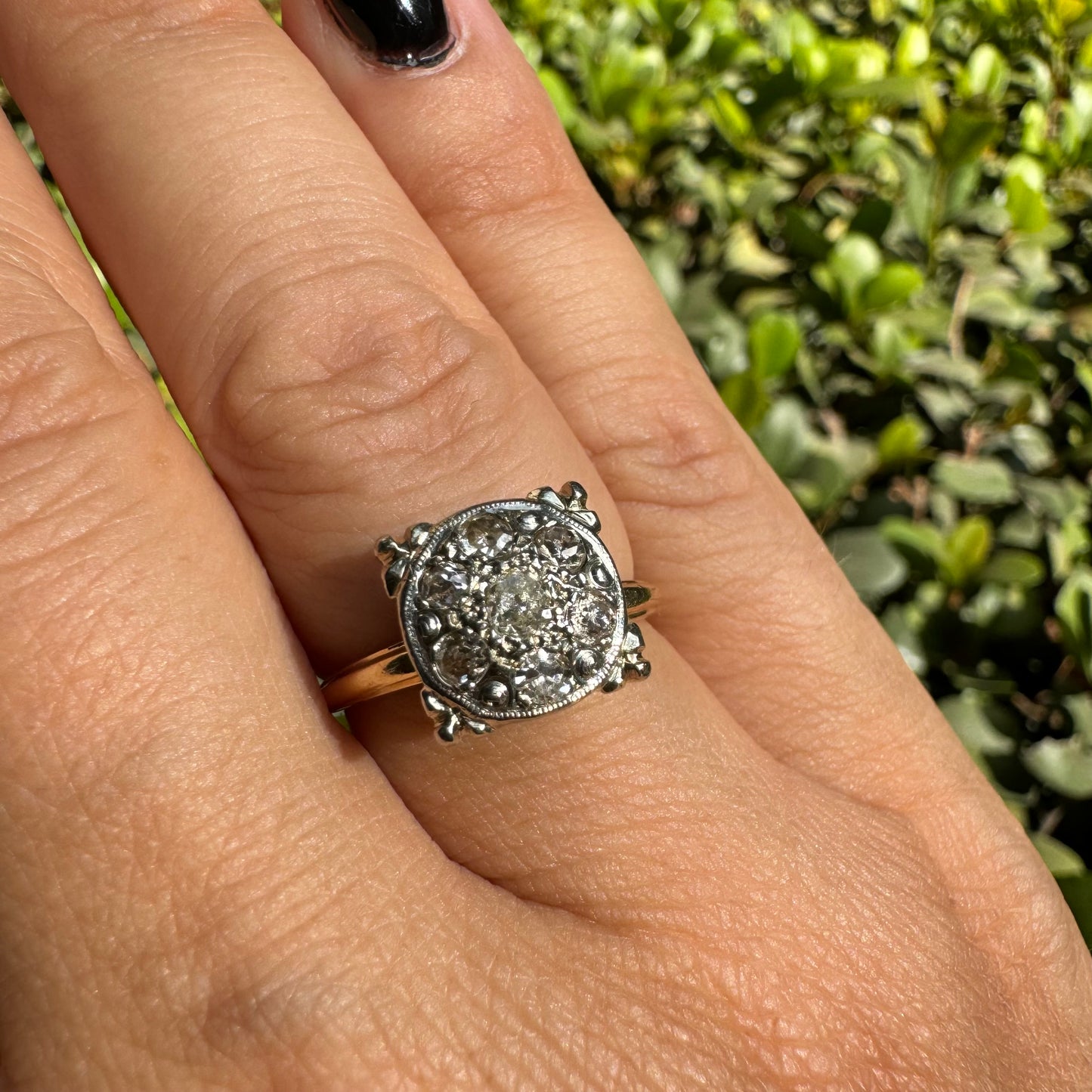 14K gold ring set with an old-cut Diamond at its center, encircled by a pavé cluster of smaller Diamonds in a round, ornate setting.