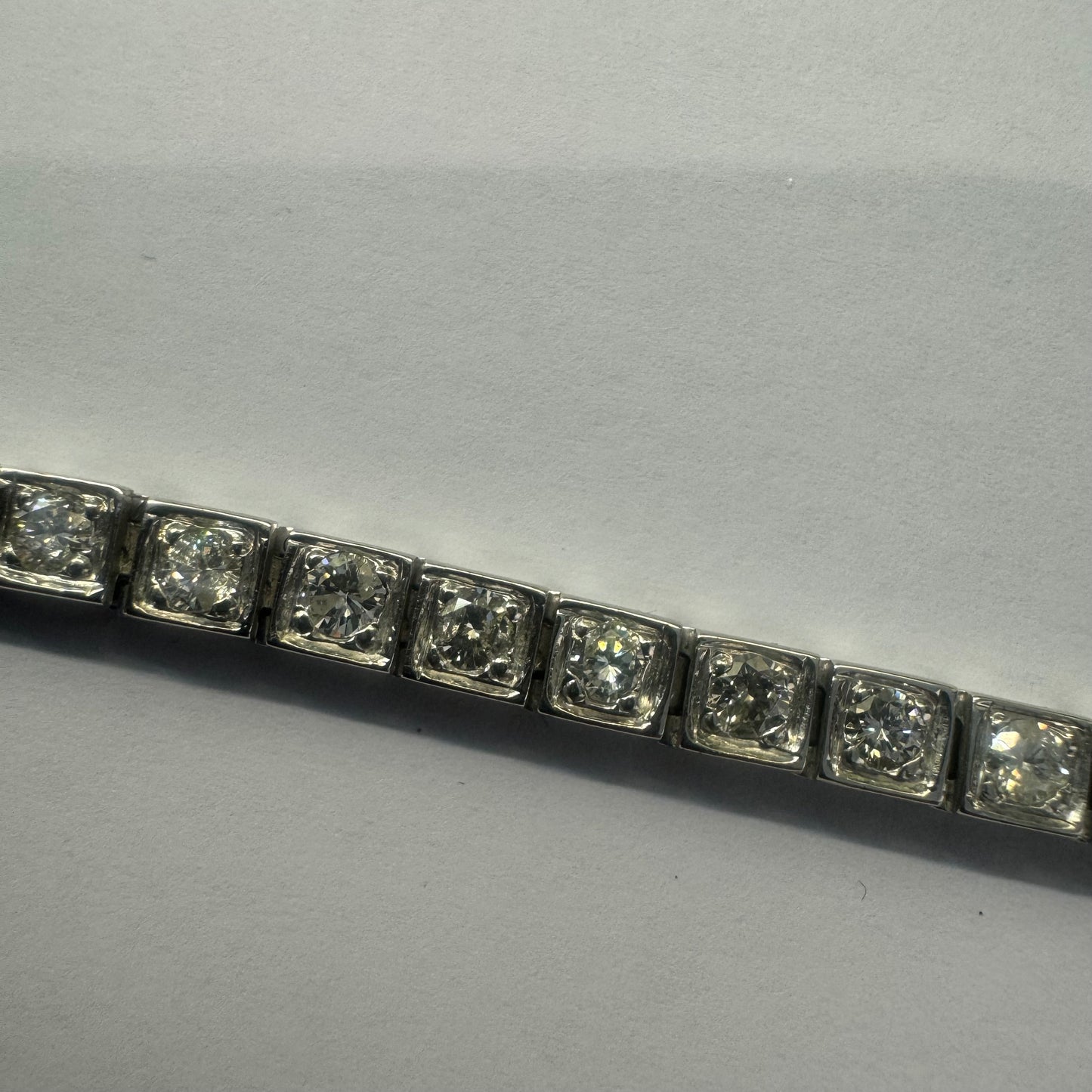 18K gold tennis bracelet set with sparkling round-cut Diamonds in square bezel settings, creating a timeless and sophisticated look.
